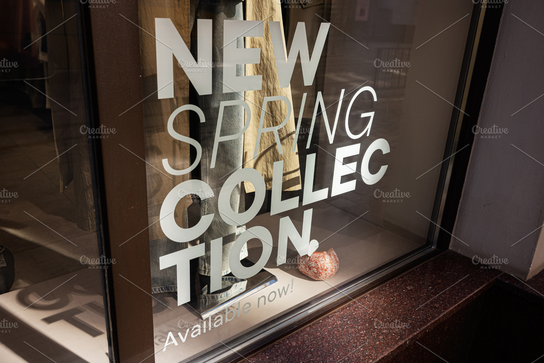 Window display featuring new clothing collection promoting spring fashion trend, a Photo by AS photostudio