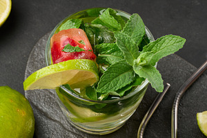 Refreshing mojito cocktail with lime, mint, strawberry, and ice, a Food & Drink Photo by ndanko
