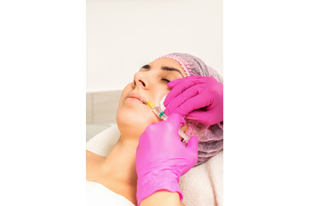 Young caucasian woman getting botox, a Health & Medical Photo by okskukuruza