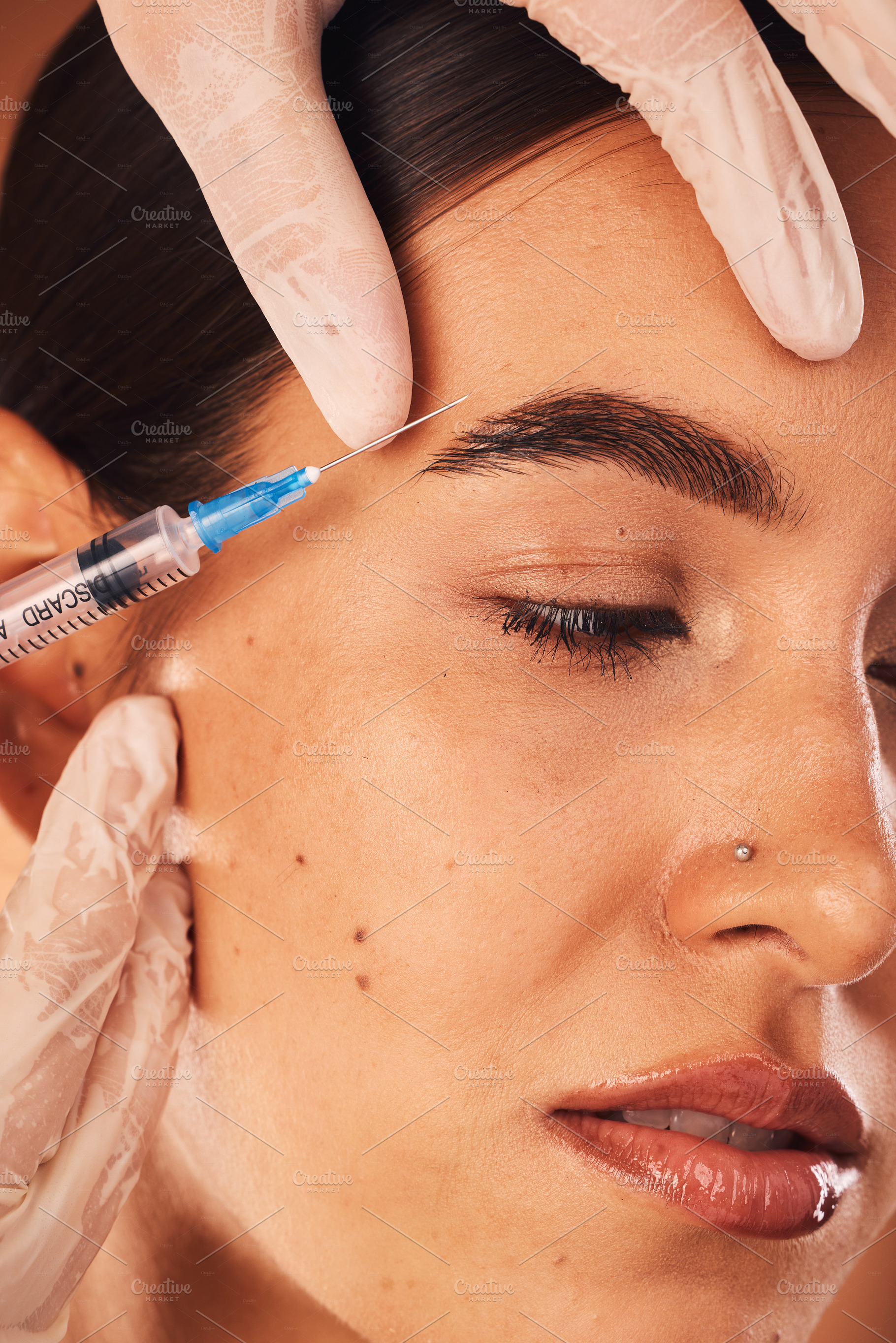 Botox, hands and woman in beauty surgery procedure for skincare, change and collagen filler, calm and content. Plastic surgery, girl and hands of surgeon with needle for treatment, lift and makeover, a Photo by Peopleimages.com