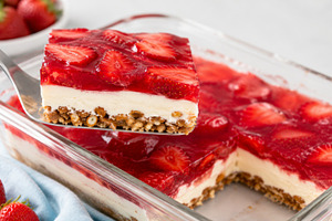 Strawberry jello salad in glass dish with cream layer and granol, a Photo by Dvoevnore photos