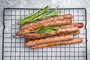 Flavorful grilled sausage links on a rack, inviting you to enjoy, a Food & Drink Photo by composter-box@mail.ru