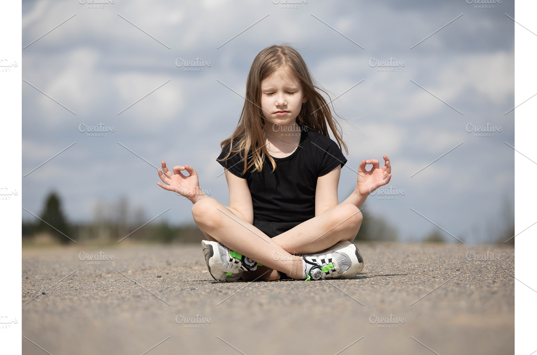 Girl in lotus position meditating on, a Person Photo by Nenahliadava Design