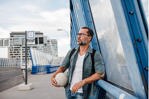 Bearded man with ball under arm, a Person Photo by HalfPoint