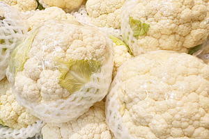 Cauliflower pile in plastic wrap, a Food & Drink Photo by ArtBackground