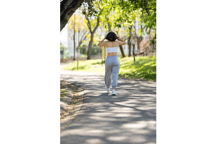 A woman is walking down a path in a