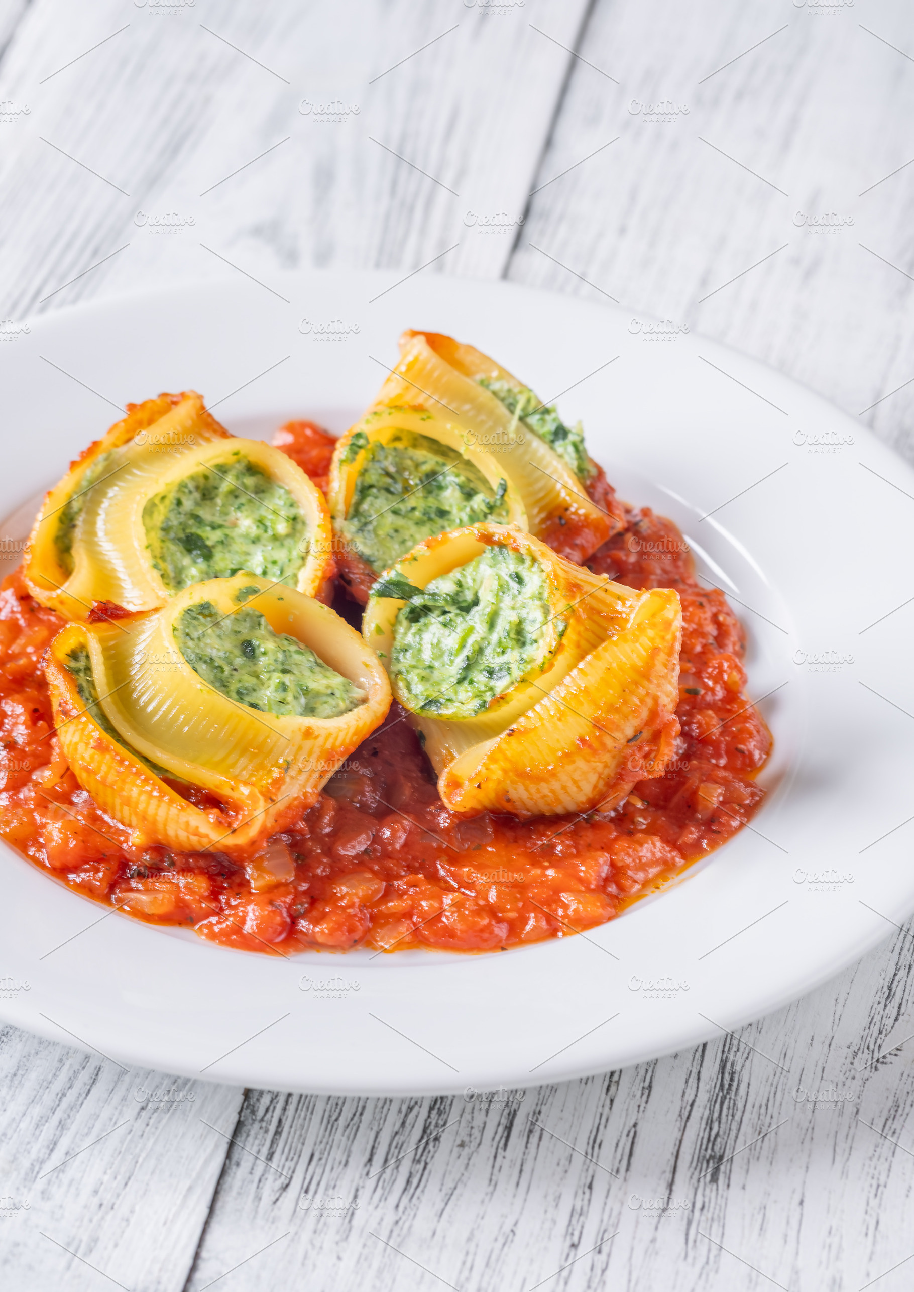 Plated lumaconi stuffed with ricotta, a Food & Drink Photo by Alexander Prokopenko