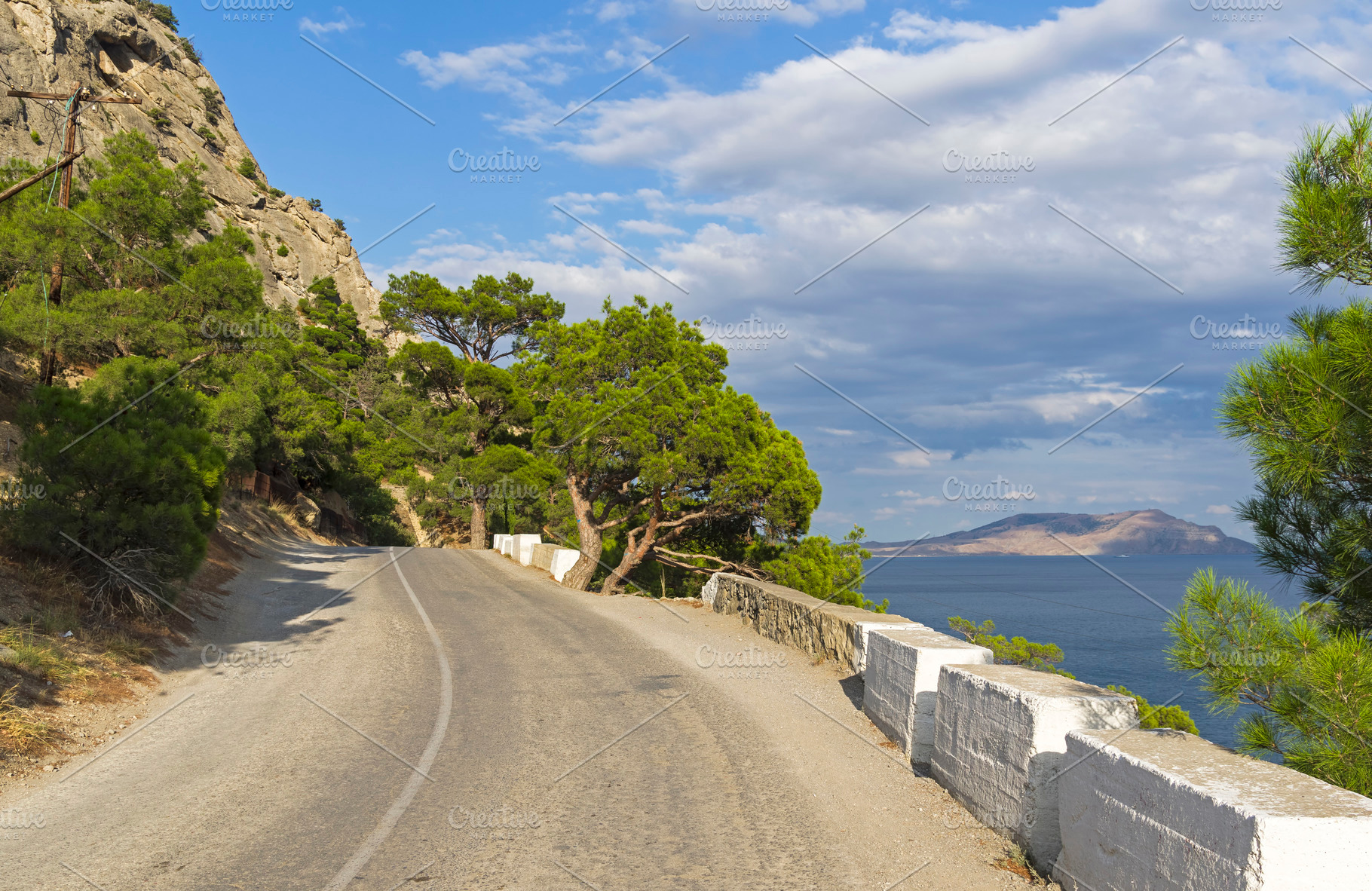 A mountain road along the seashore stock photo containing pine and relic, a Nature Photo by possum