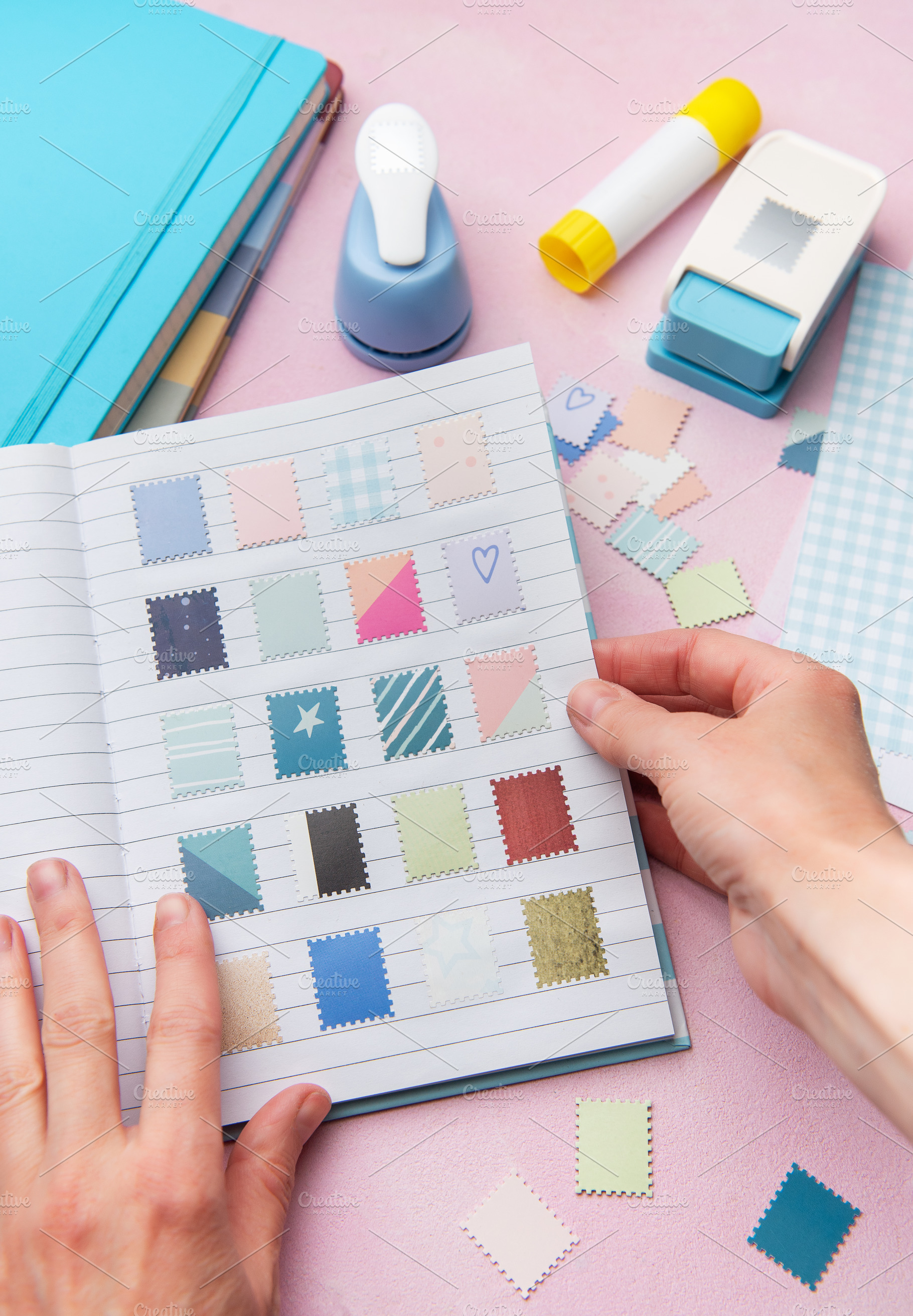 Hands creating a scrapbook with decorative paper punches, an Arts & Entertainment Photo by Olena Rudo