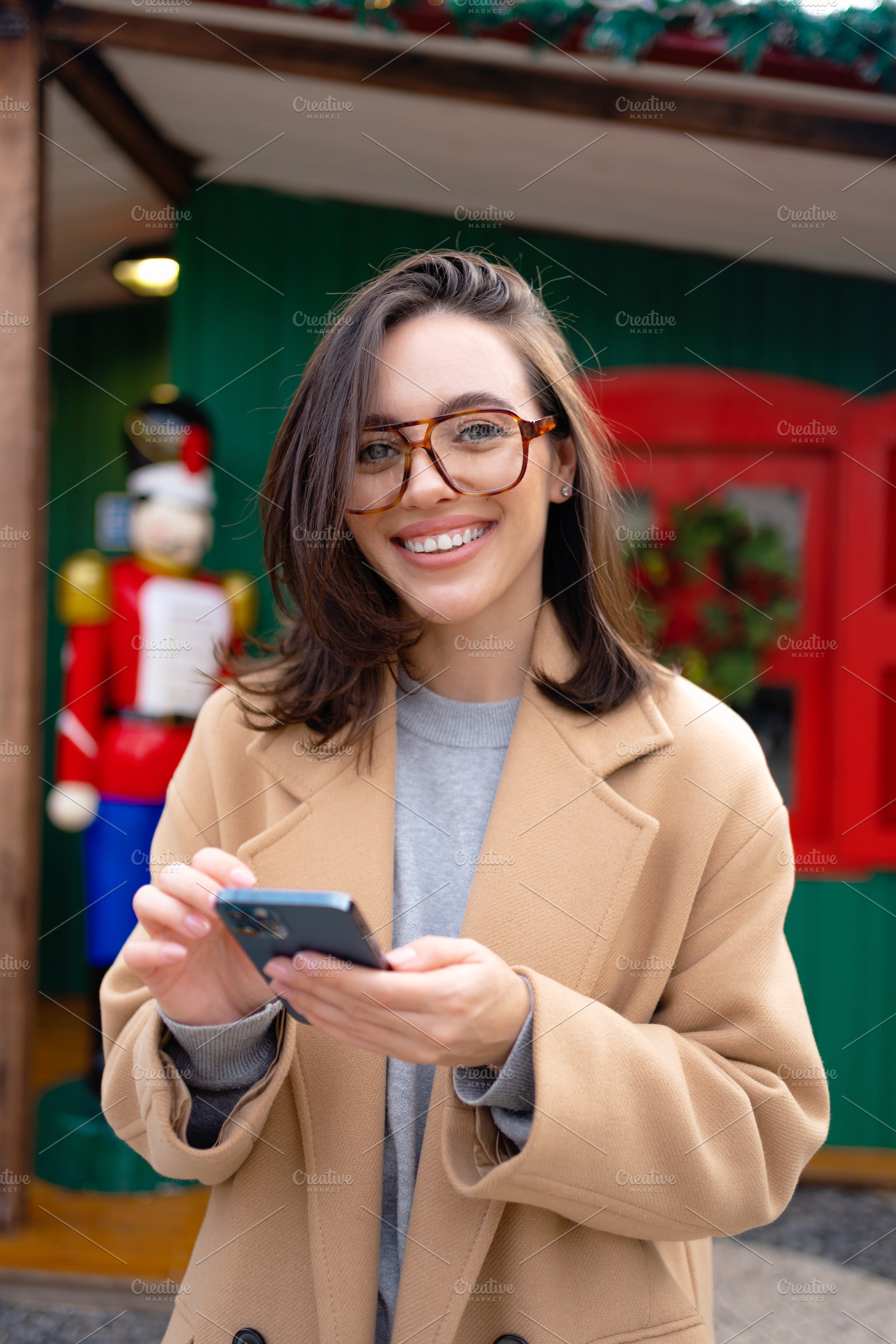 Woman in glasses using mobile phone at day in the city, a Person Photo by andreonegin market
