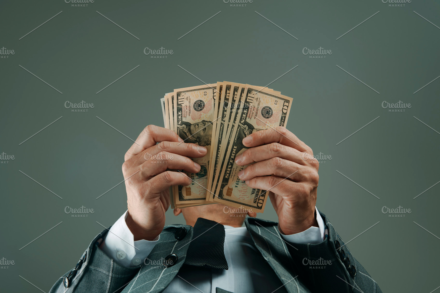 businessman, seen from below, with some dollars, a Photo by Nito