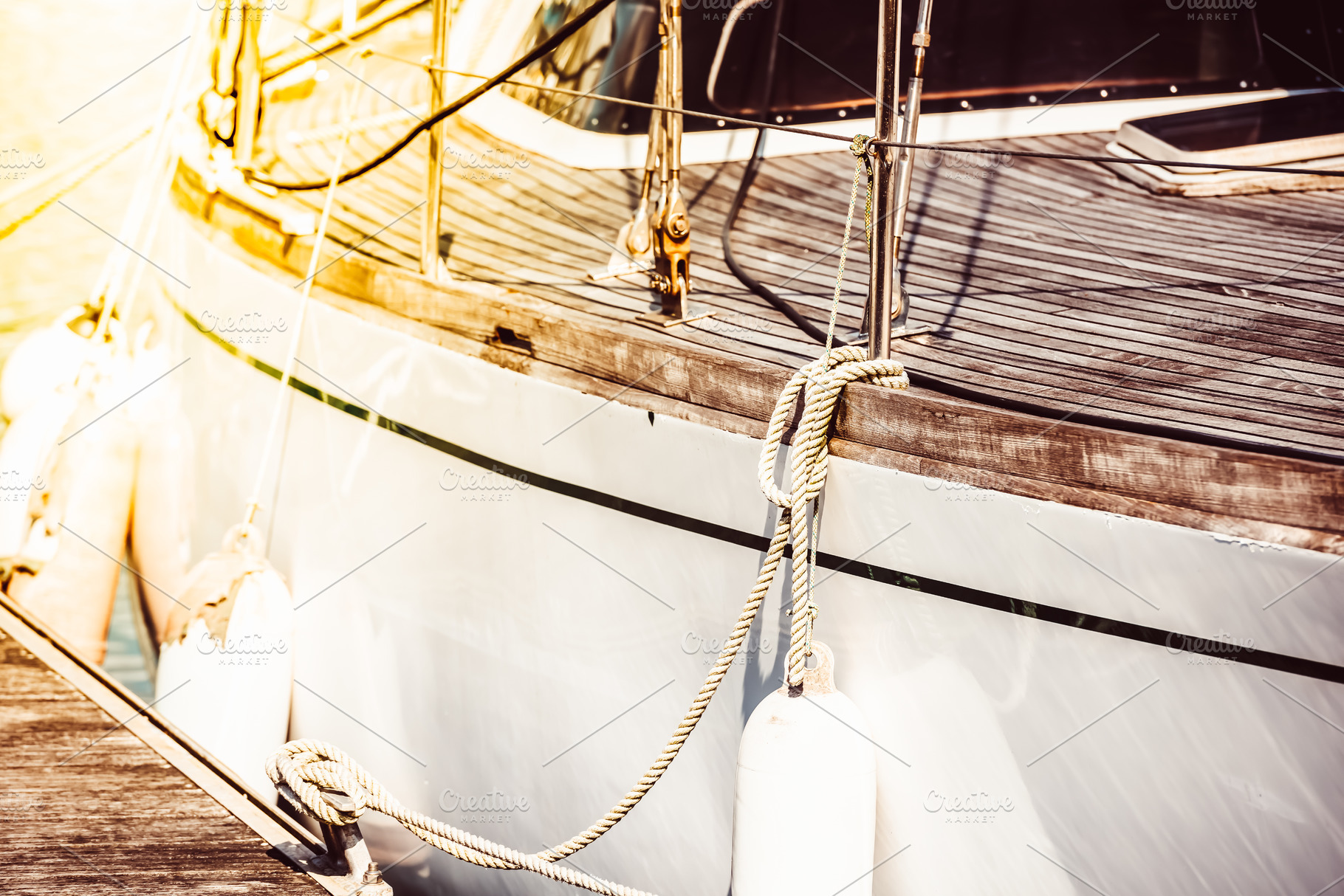 Sailboat deck ropes closeup with sun, a Photo by Dvoevnore photos