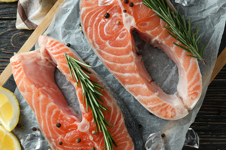 Concept of cooking salmon on wooden table, a Food & Drink Photo by AtlasStudio PRO