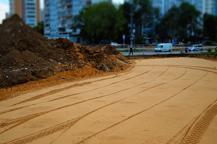 Car tire traces on the sand construction place, an Architecture Photo by RETROWAVE '88