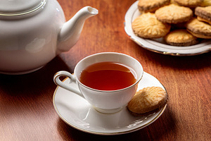 Black tea with cookies in classic white porcelain glassware, a Food & Drink Photo by Davizro's Market