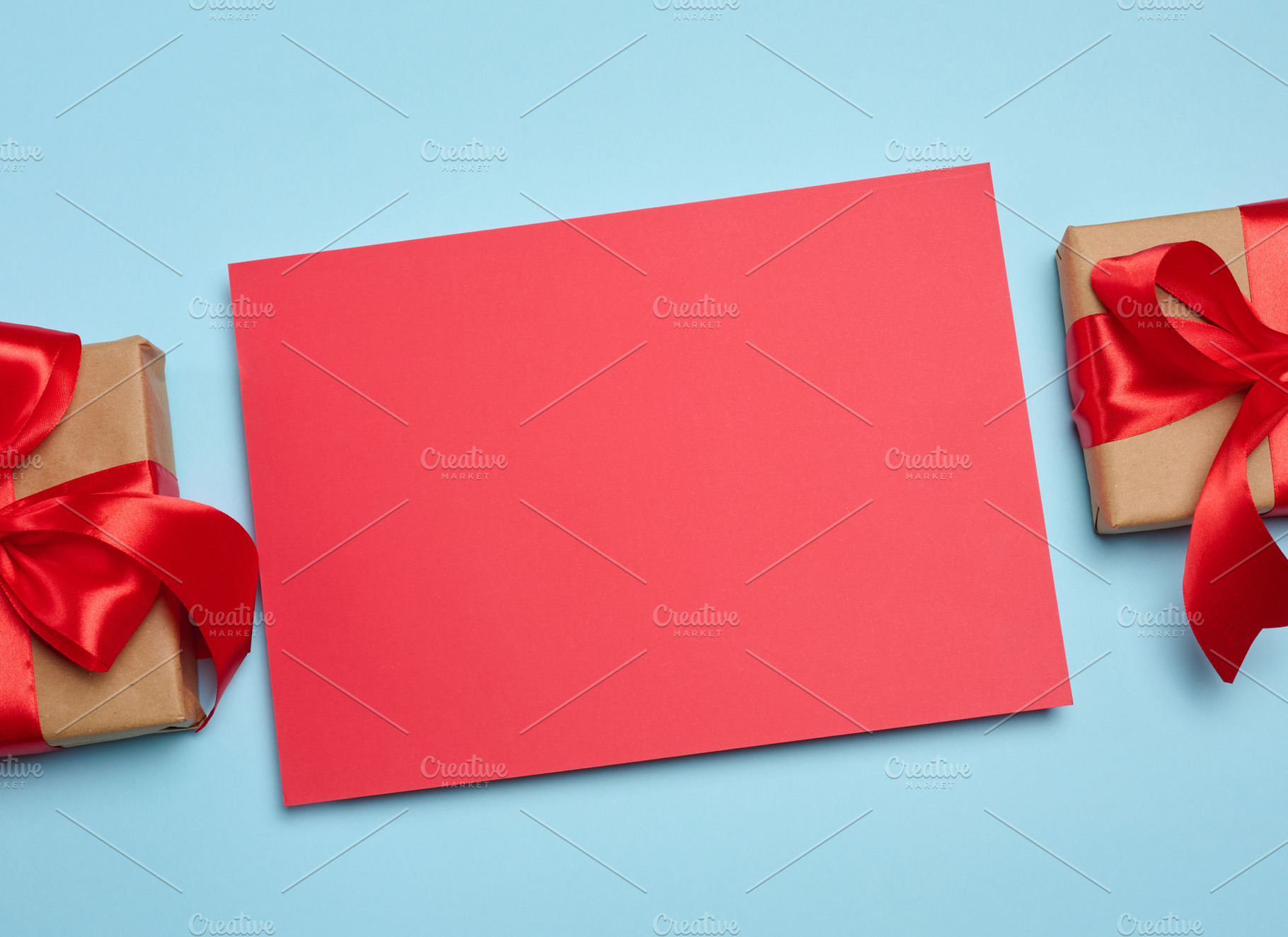 A red, blank rectangular sheet of paper between two craft-wrappe, a Holiday Photo by ndanko