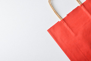 Empty and folded red paper shopping bag on white, an Industrial Photo by Davizro's Market