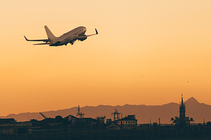 Airplane takeoff at sunset, a Transportation Photo by SkyNext