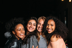 Group of four laughing females, a Person Photo by Artem Varnitsin