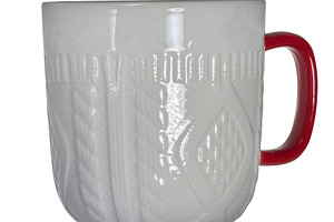 White ceramic mug with knitted relief and red handle on isolated, a Beauty & Fashion Photo by ndanko