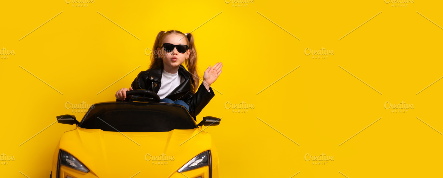 Stylish young girl wearing sunglasses and leather jacket drives, a Person Photo by Ales Munt