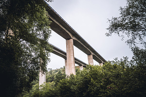 Bridge over forest valley landscape, an Architecture Photo by SkyNext