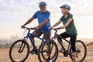 Multiracial senior couple riding bicycles together on outdoor tr, a Sports & Recreation Photo by Volff