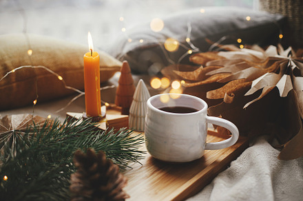 Merry Christmas. Warm cup of tea, christmas stars, golden lights, a Holiday Photo by Sonjachni