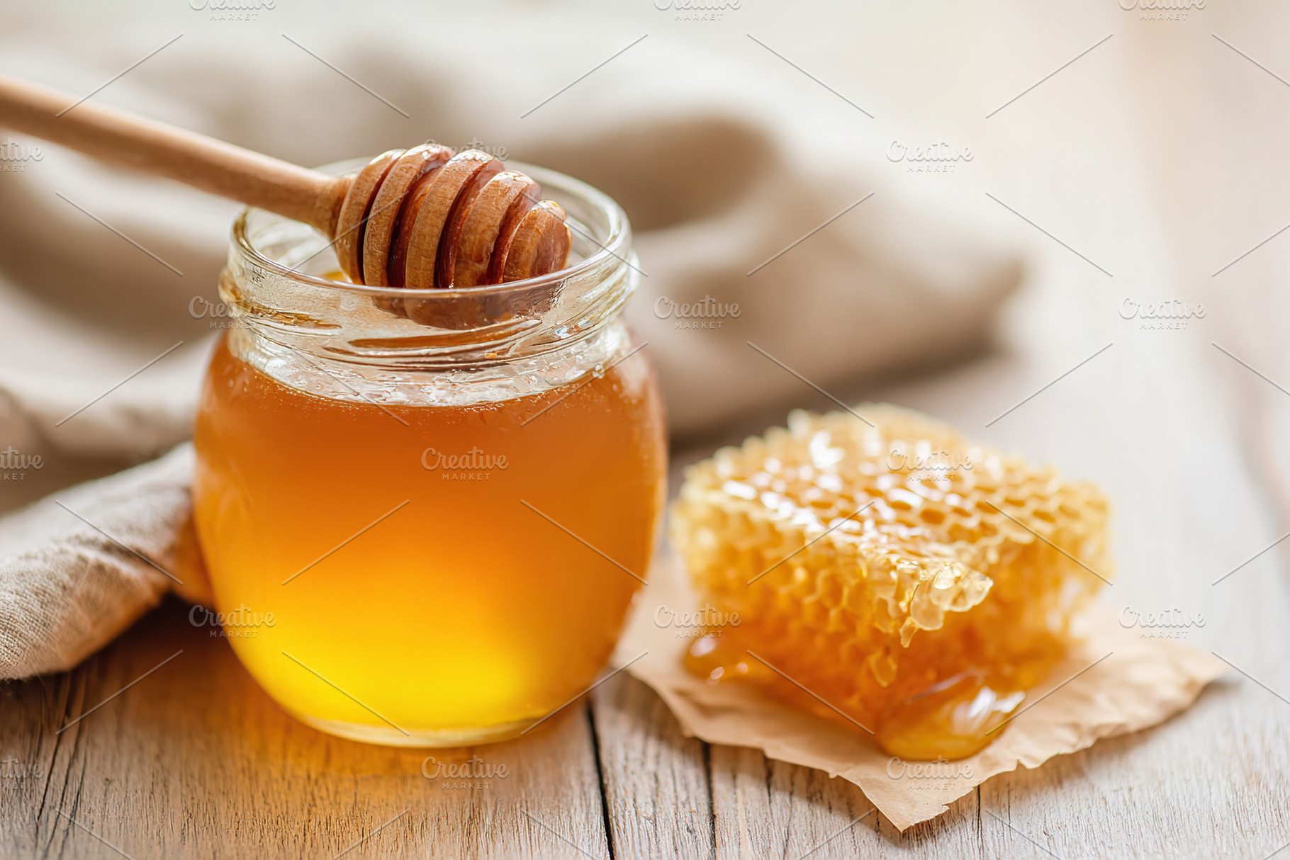 Honey and honeycomb displayed on a wooden table with soft natural light in the, a Food & Drink Photo by AlyaAnd