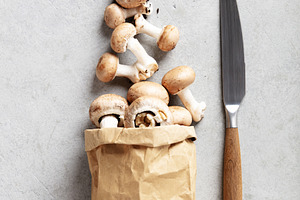 Fresh Brown Mushrooms in a Paper Bag on Light Stone Background, a Food & Drink Photo by Natalia Klenova's Shop