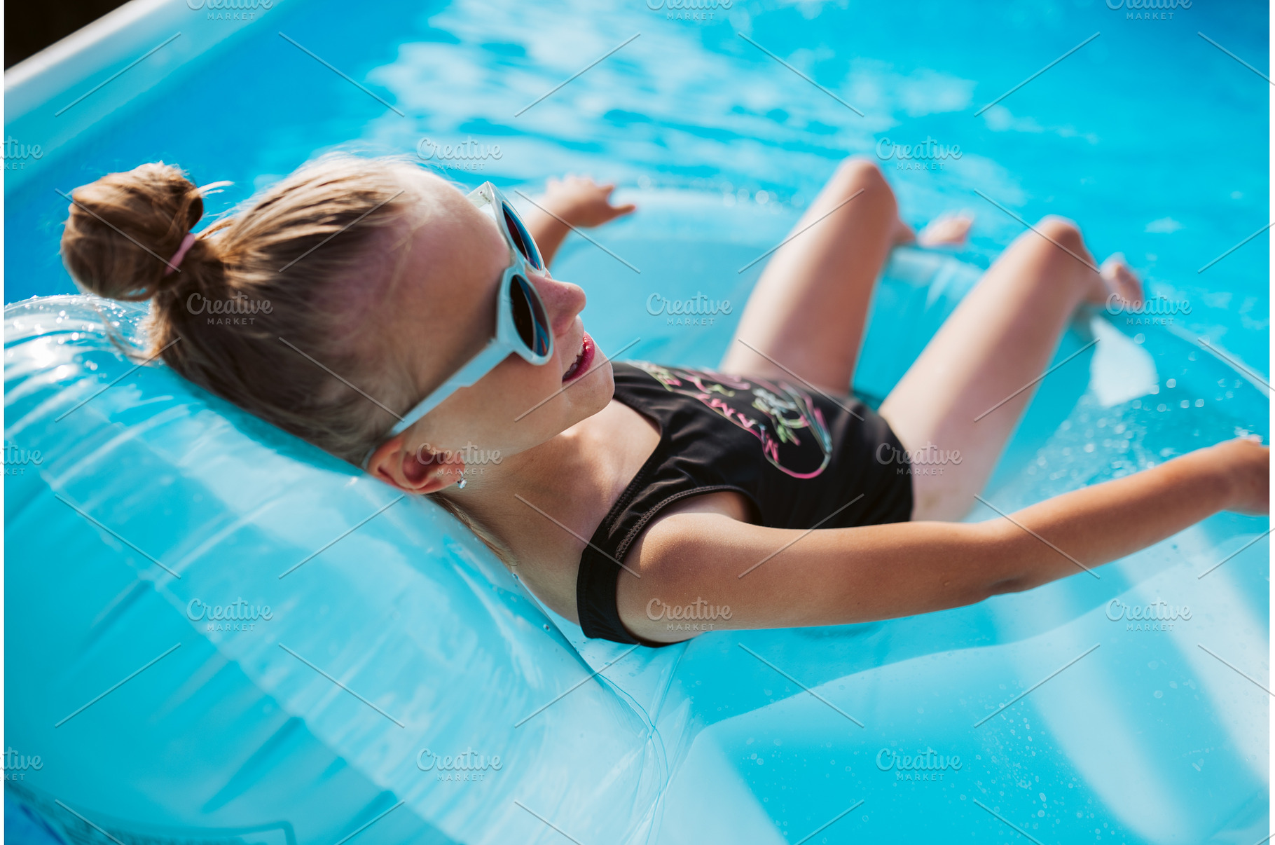 Girl lying on inflatable chair in, a Sports & Recreation Photo by HalfPoint
