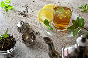 Freshly brewed green tea with lemon on a wooden table, a Food & Drink Photo by Davizro's Market