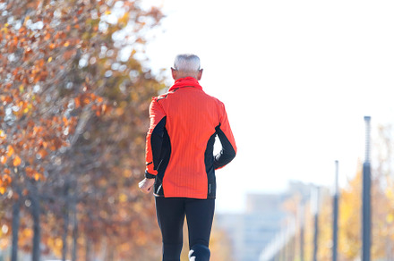 Senior man jogging in the park on a sunny day