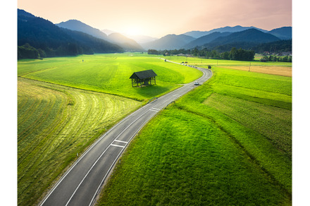 Aerial view of road in green meadows, a Nature Photo by den-belitsky