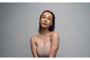 Young woman applying luxurious gold, a Health & Medical Photo by volodymyrshtun13795