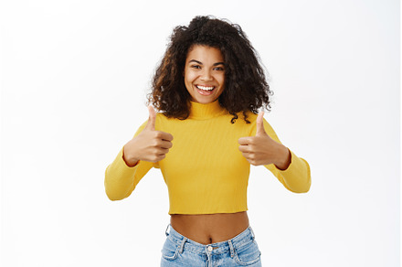 Smiling black girl showing thumbs up