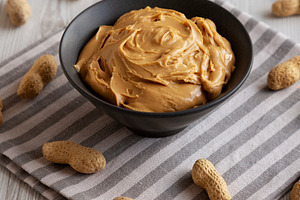 Organic Creamy Peanut Butter in a Bowl, side view., a Food & Drink Photo by LiudmylaChuhunova