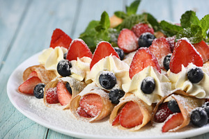 French crepes with cream and berries, a Food & Drink Photo by Apolonia