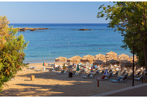 Sandy Beach with Thatched Parasols