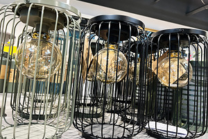 Modern industrial light fixtures with glass bulbs and wire designs, a Photo by AS photostudio