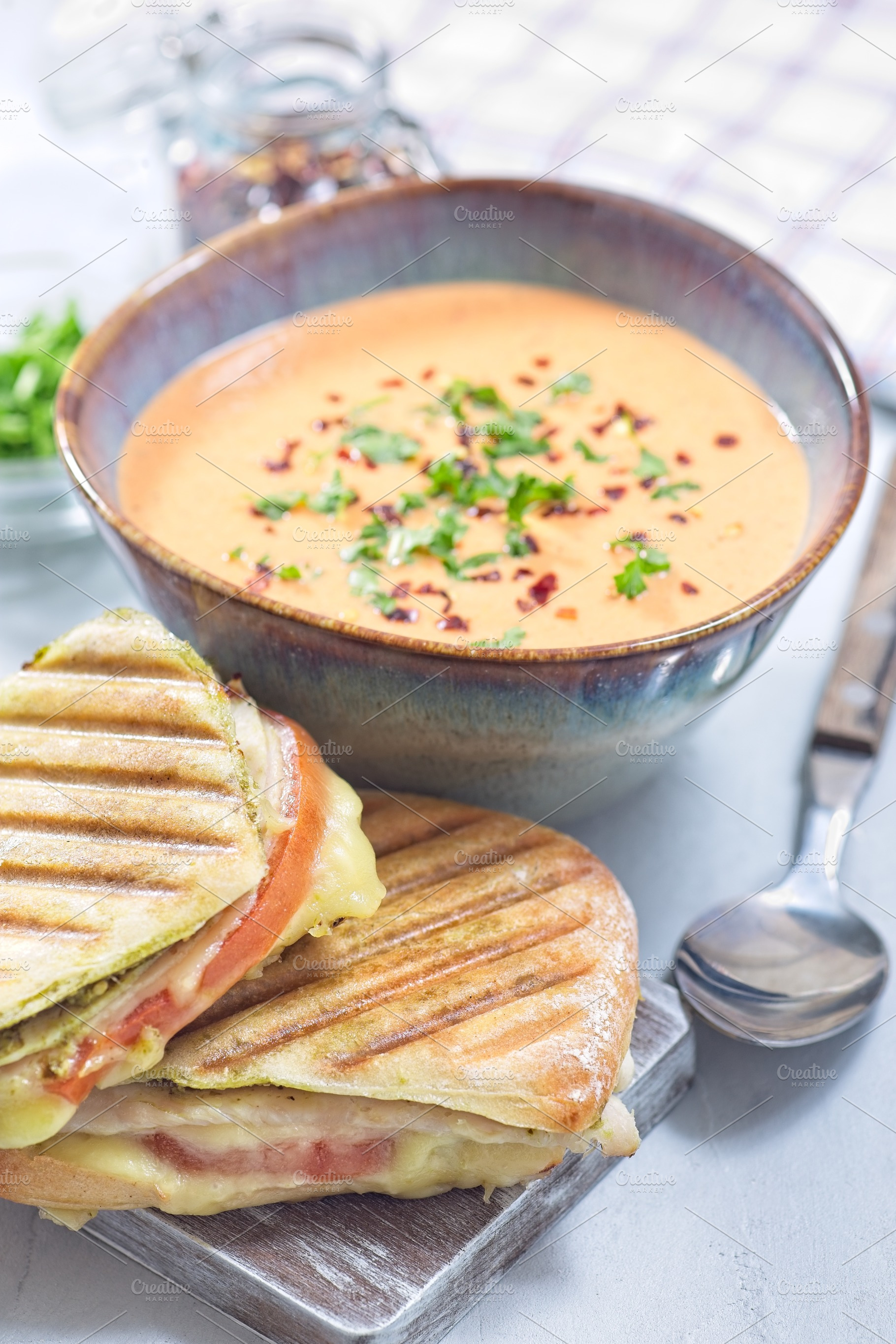 Red bell pepper cream soup served with grilled turkey panini, vertical, a Food & Drink Photo by iuliia_n