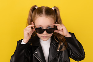 Stylish young girl in a black leather jacket adjusting her sungl, a Person Photo by Ales Munt