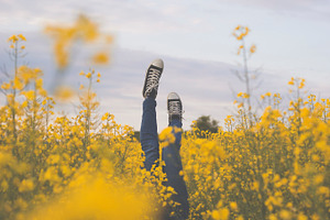 Girl upside down in a rapeseed field