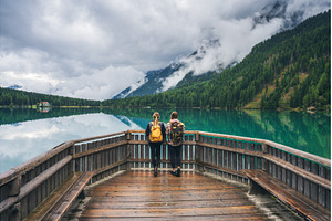 Two women with backpacks standing on, a Person Photo by den-belitsky