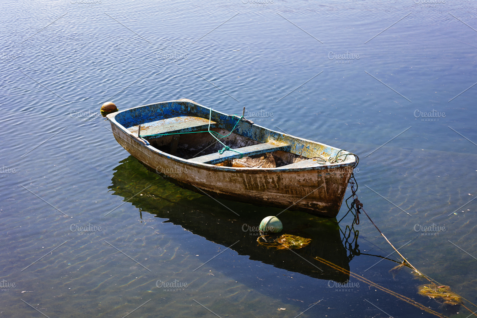 Small fishing boat moored and floati, a Transportation Photo by Perpis