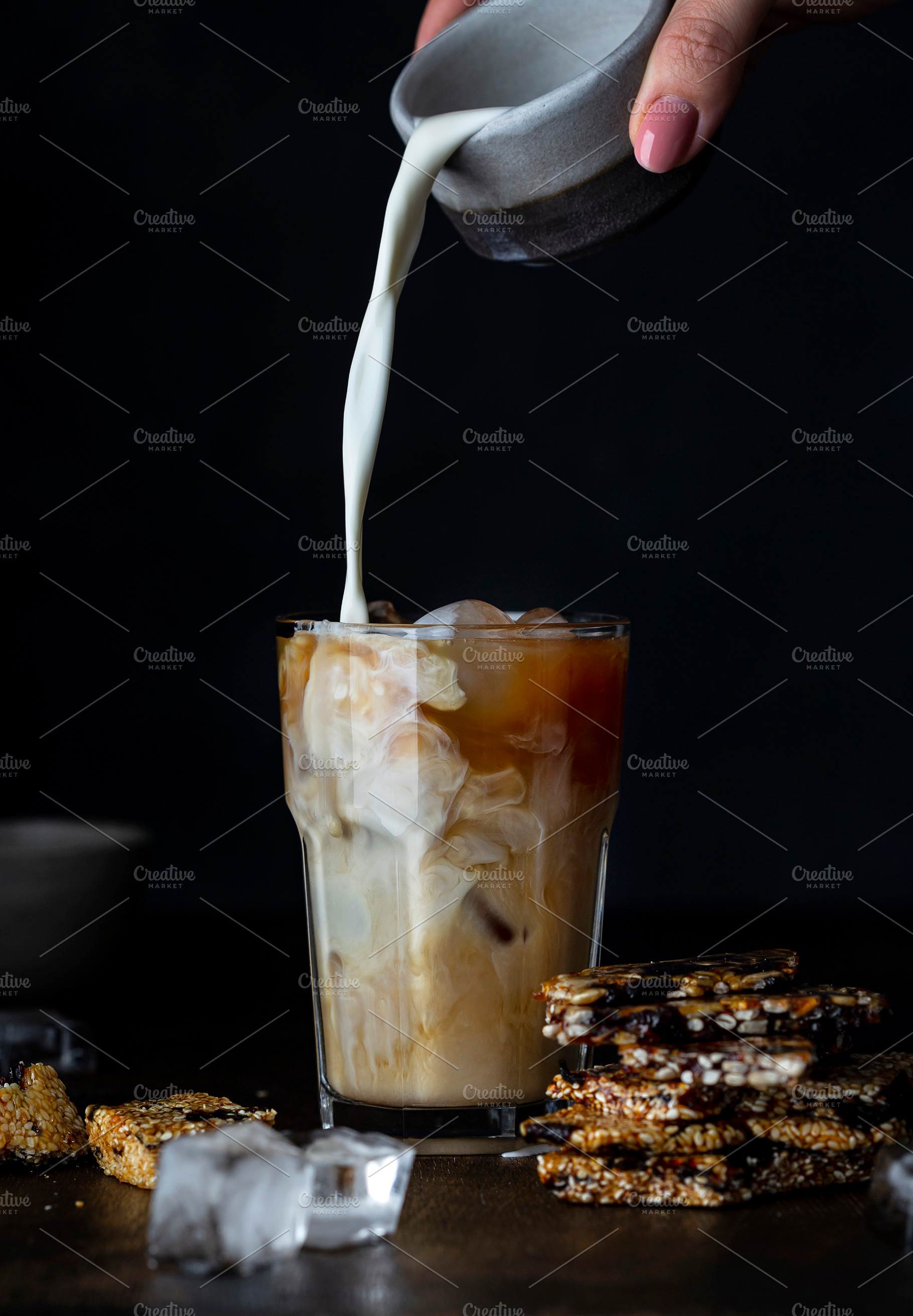 Iced coffee in a glass with milk, a Food & Drink Photo by Marina_Pronina