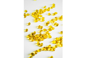 Bright yellow oval capsules, a Health & Medical Photo by volodymyrshtun13795