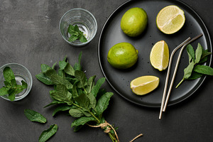 Bunch of fresh green mint, lime slices, glasses, top view. Cockt, a Food & Drink Photo by ndanko