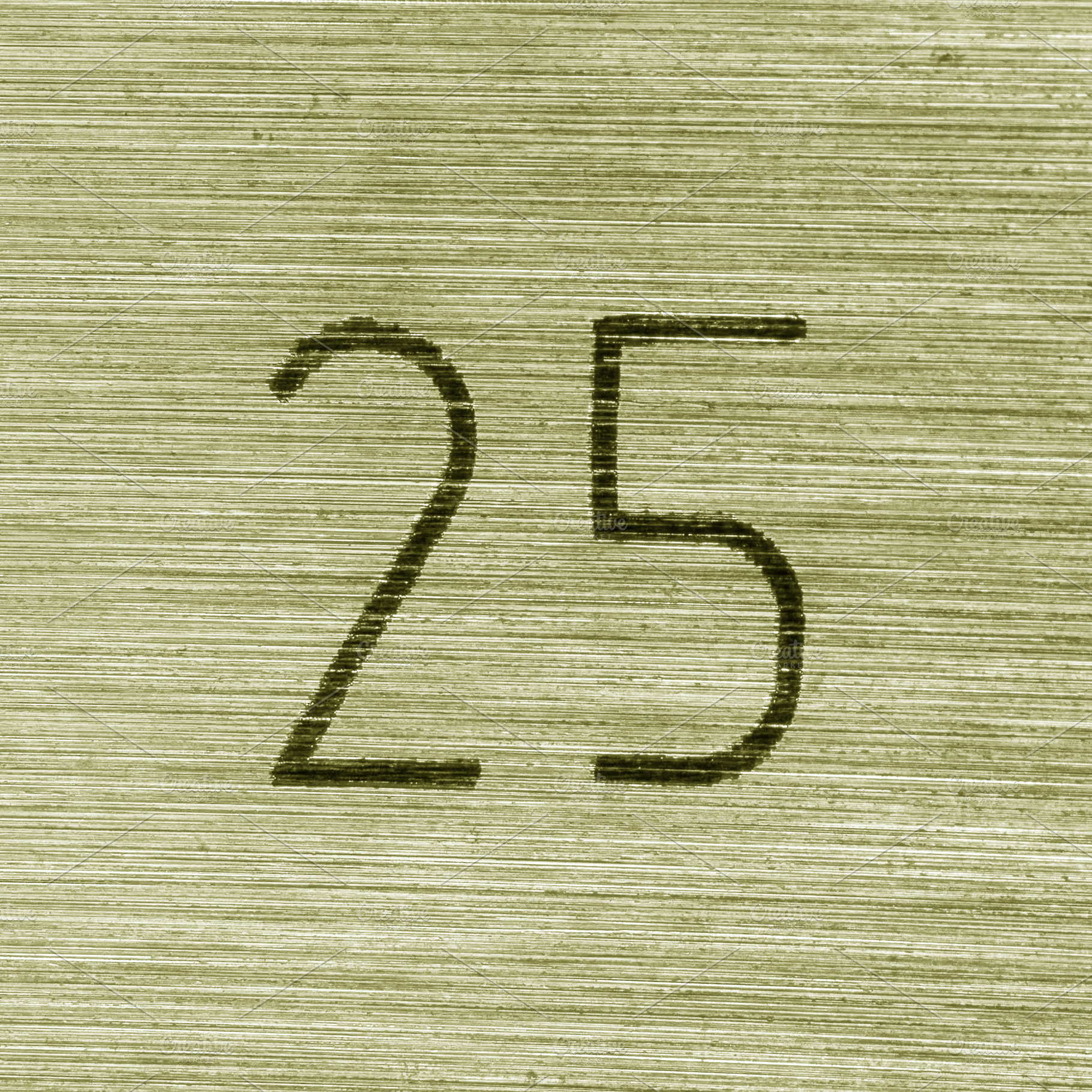 Scratched golden numbers 25 or twenty five on a piece metallic p, a Background Photo by Eugene_Photo