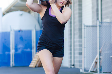 Crossfit barrel carry  young woman stock photo containing crossfit and fitness